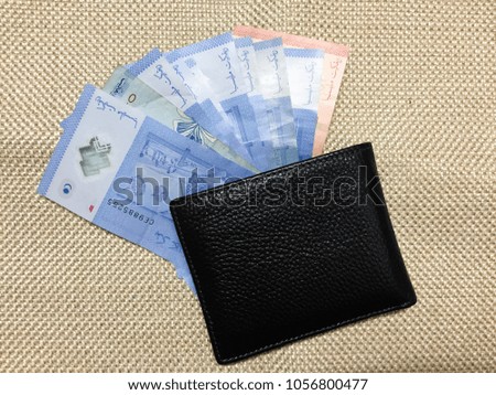 Few Notes of "Malaysia Ringgit" in a leather wallet from above view.Business investment concept, Financial concept. Visible Noise,Blur When View at Full Resolution.