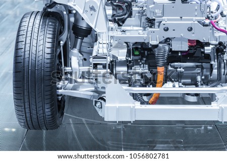 Chassis of the electric, hybrid car with powertrain. Car maintenance. Blue toned. Royalty-Free Stock Photo #1056802781