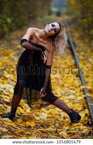 Dead horror warlock woman, scary female witch possessed by evil spirits. Book cover idea, day, park, autumn