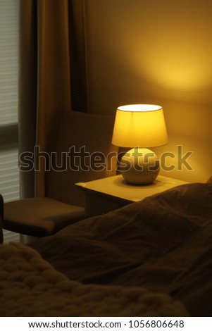 Bedroom with lamp . Knitted bedspread . Lamp Royalty-Free Stock Photo #1056806648