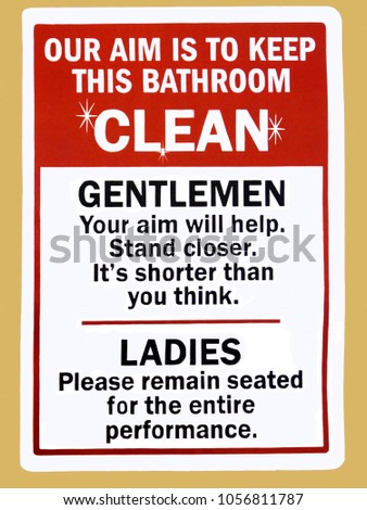 An instruction sign in a public toilet advising gentleman and ladies how to keep the bathroom clean                      Royalty-Free Stock Photo #1056811787