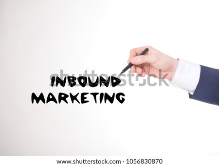 The businessman writes a black marker inscription:INBOUND MARKETING