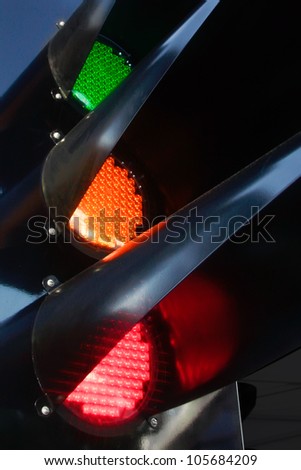 traffic light glowing of the different colors of green, red and yellow black steel mechanism