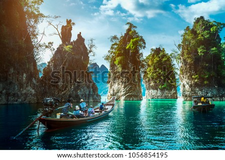 Landscape of Khao Sok National Park with longtail boat for travelers, Cheow Lan lake, Ratchaphapha dam, Travel nature in Thailand, Beautiful destination place Asia, Summer outdoor vacation travel trip Royalty-Free Stock Photo #1056854195