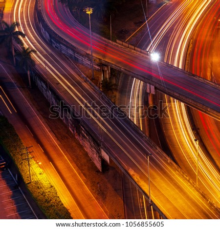 Square format of a long exposure with highways and bridges in the financial district of Panama City with light trails, Panama. Expression of speed and traffic.