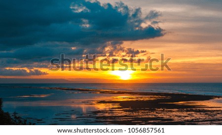 Beautiful cloudscape over the sea, sunrise shot. Tropical sunrise on the beach. Bali island. Indonesia