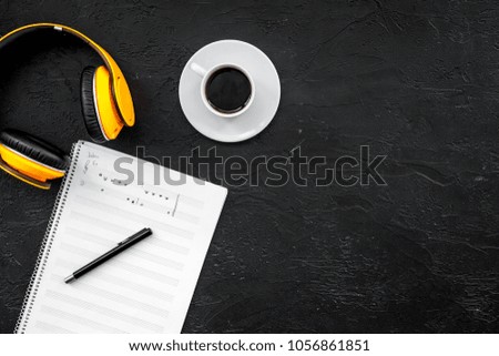 Work space of composer or dj with headphones and notes black background top view mock-up