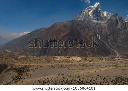 small people bottom of a  picture with Taboche mt. background. view during way from Dingboche to Lobuche