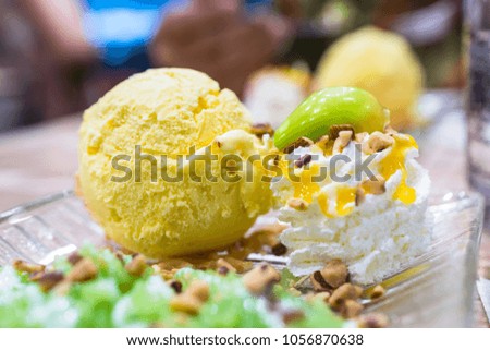 Mango ice cream with toppings, whip cream, Almond, Green Sticky rice, Fruit Shaped Mung Beans in Jelly.