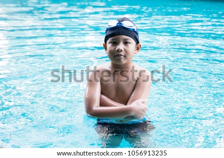 Asian handsome boy, standing in the swimming pool, feeling confident, eye contact shot, kid model shooting photography.