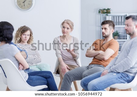 Separated couple and their young adult children resolving family issues in group therapy Royalty-Free Stock Photo #1056944972