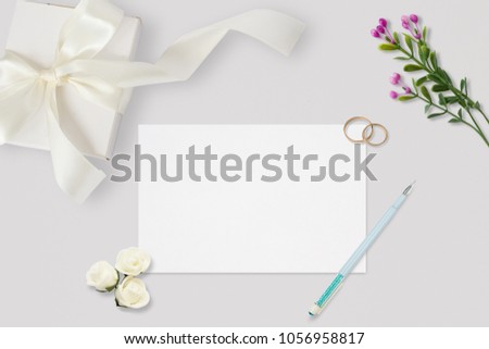 Styled stock photo. Feminine wedding desktop mockup. White roses, satin ribbon, beads on pastel gray background. Copy space. Top view. Picture for blog