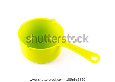 Measuring spoon or cup over white background.