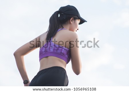 Young woman runner is jogging on the street be running for exercise.