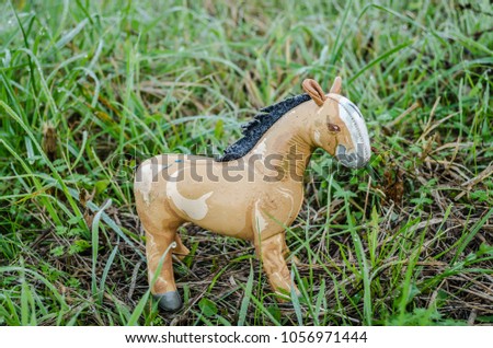 Children's toy horse on the grass 