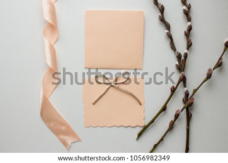 Workspace. Wedding invitation cards, peach envelopes, ribbons, pussy willow on white background. Overhead view. Flat lay, top view invitation card. copy space. mockup