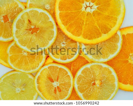 Slices of fresh orange and lemon texture background.