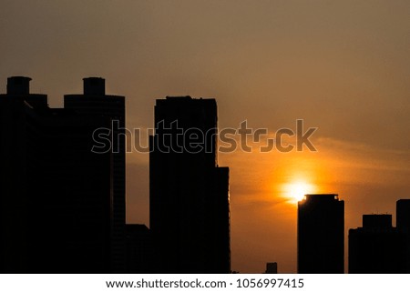 Silhouette cityscape before sunset.
