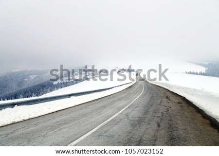 Aerial view above the mountain road Royalty-Free Stock Photo #1057023152
