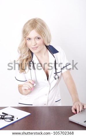 Portrait of a young attractive female doctor working at the office.