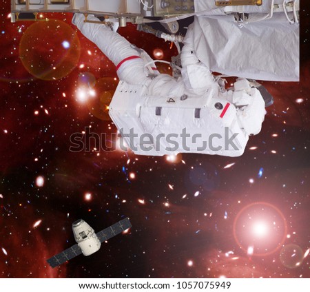Astronaut fixing the starship. The elements of this image furnished by NASA.
