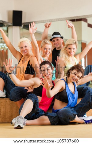 young people dancing in a studio or gym doing sports or practicing a dance number