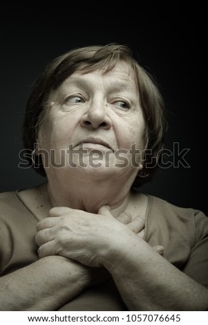 Studio portrait of elderly woman. Inspiration or dreaminess. Toned.