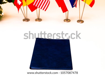 Flags of different countries on the background of the white table. Selective focus. Shallow depth of field. Toned.