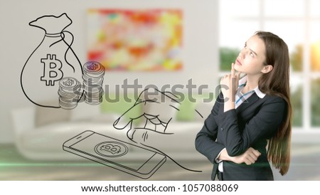 Surprised smiling young woman wearing a suit and looking at a cryptocurrency sketch on a design flat wall. Concept of Bitcoin risk.