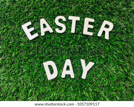 Image Easter Day, wooden alphabet Easter Day on green grass background with space for your text and design. Concept be used for holiday, banner, billboard, wallpaper and desktop. Blur picture.