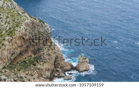 Wide view of Cape Formentor viewpoint with blurred tourists and coastline in Mallorca
