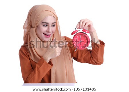 Beautiful Asian Muslim woman with clock alarm. Conceptual of Beauty, learning, business or important day with white background