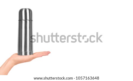 metal thermos for trips in hand isolated on white background. copy space, template.