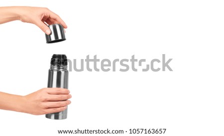 metal thermos for trips in hand isolated on white background. copy space, template.