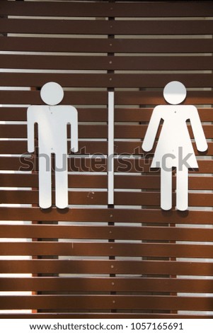 Badges for men and women at restroom in the park.