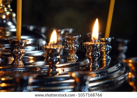 Burning candles in the Church .