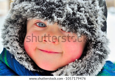 Boy in winter hat smiling