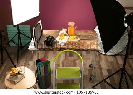 Cut oranges and jug with juice on table. Food photography