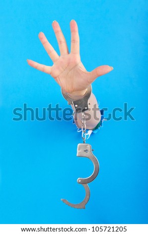 Hand with handcuffs out of paper