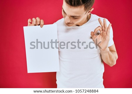  man holds a sheet of paper, place free                              