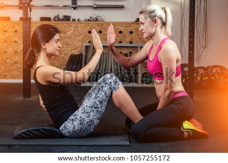 girl in the gym doing exercises for the press teamwork