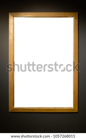  Wooden vertical frame with blank canvas on blue wall