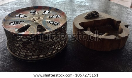 Wood craving ashtray and mosquito repellent box on wood table