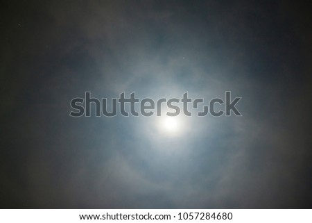Abstract of light of full moon with cloud on dark sky on night.