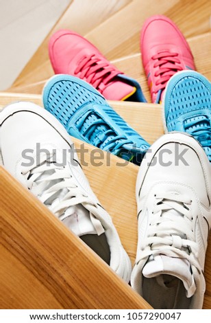 Showcase with sports shoes. Pink, white and blue sneakers.