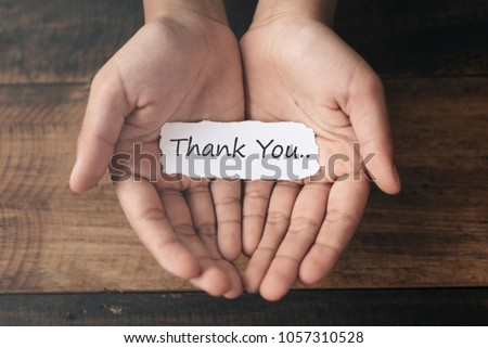 a boy with a paper note in his hands with the words THANK YOU. Appreciation concept Royalty-Free Stock Photo #1057310528