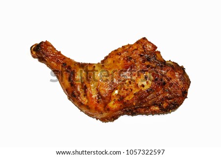 Roasted chicken leg on a white background. Royalty-Free Stock Photo #1057322597