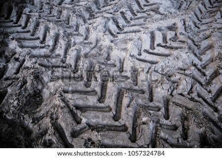 Tyre track on dirt sand or mud, Picture in retro or grunge tone. Car drive on sand. off road track. Tractor wheel tracks.