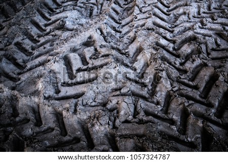 Tyre track on dirt sand or mud, Picture in retro or grunge tone. Car drive on sand. off road track. Tractor wheel tracks.
