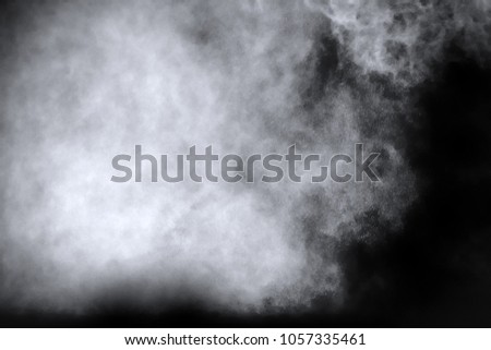 Splash of white powder over black background.